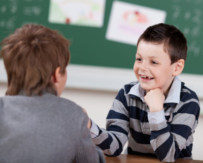 two boys talking in classroom